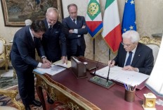 This handout picture released by the Italian Presidency shows newly appointed Italian Prime Minister Giuseppe Conte (left) and Italy's President Sergio Mattarella (right) signing the list of the new cabinet on May 31, 2018 at the Quirinale presidential palace in Rome. 

