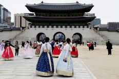 Tourists in the traditional Korean 'hanbok' dress take photos at Seoul's Gyeongbokgung Palace, the main palace of the Joseon dynasty.
