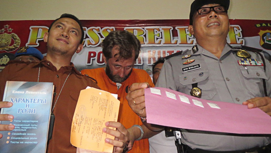 Detained: In a press conference on Wednesday, Kuta Police present evidence confiscated from Russian citizen Vladimir Aleksandrovich Rybnokov (center), 44, who has been arrested for allegedly selling drugs.