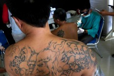 Next in line: People with tattoos wait for their turn to have their tattoos removed. JP/Maksum Nur Fauzan