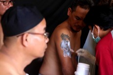 Marking the area: A man begins the tattoo removal process. JP/Maksum Nur Fauzan