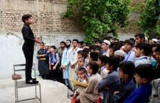 In this picture taken on April 3, 2018, 11-year-old Pakistani motivational coach Hammad Safi lectures students at a languages academy in Peshawar. Elegantly dressed, his gestures confident, Safi speaks into a wireless microphone before an enraptured audience in Pakistan.