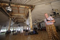 A Danish tourist wears a sarong upon entering the mosque, as required. JP/Boy T. Harjanto