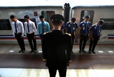 Bless us: A train conductor leads a prayer with his staff before they leave from Pasar Senen Station in Jakarta to Malang in East Java.JP/Dhoni Setiawan