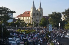 Muslims gathering for Eid prayers at the Masjid Jamik Malang on Friday, June 15, 2018 are welcomed in the yard of the Catholic Church of the Sacred Heart because the mosque could not accommodate them all. JP/Aman Rochman