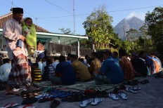 Residents of Balerante, Kemalang, Klaten regency in Central Java attend Friday prayers on June 15, 2018 in the front yard of Al Qodar Mosque. After praying, the villagers, who live on the foot of Mount Merapi, visit relatives' houses. JP/Magnus Hendratmo