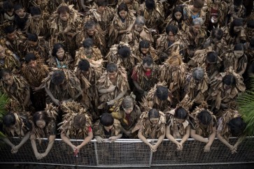Quite a mud-dle! Filipino devotees slather themselves in soil