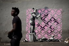 Banksy needles France with migrant mural blitz in Paris