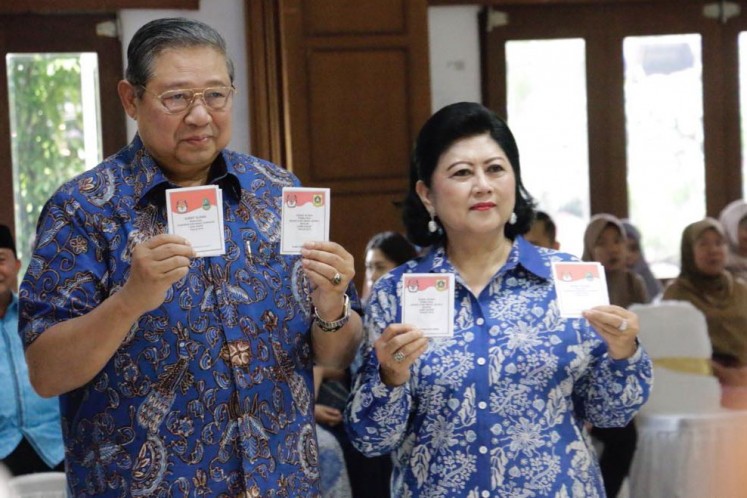 Democratic Party patron Yudhoyono and his wife Ani show their ballots to reporters during the West Java gubernatorial election at a polling station near his residence in Cikeas, West Java.