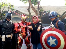 A voter poses with “Batman”, “Iron Man” and “Captain America” after casting her vote in the West Java gubernatorial election in Citarum district, Bandung, West Java on Wednesday, June 27, 2018.  JP/Dewi Yulianti