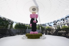 Thousands of flowers used to build KAWS sculpture for Dior