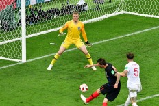 Croatia's forward Mario Mandzukic (C) scores his team's second goal past England's goalkeeper Jordan Pickford (left) during the Russia 2018 World Cup semi-final football match between Croatia and England at the Luzhniki Stadium in Moscow on July 11, 2018. 