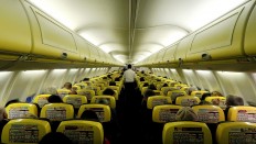 A cabin crew member serves passengers onboard a Ryanair passenger aircraft traveling from Madrid International Airport to Bergamo Airport, Italy, January 13, 2018. 
