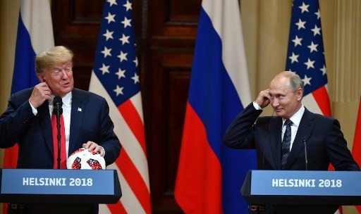 US President Donald Trump (L) and Russia's President Vladimir Putin smile as they attend a joint press conference after a meeting at the Presidential Palace in Helsinki, on July 16, 2018. The US and Russian leaders opened an historic summit in Helsinki, with Donald Trump promising an 