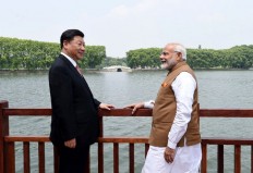 This handout photograph released by India's Press Information Bureau (PIB) on April 28, 2018 shows India's Prime Minister Narendra Modi (right) and Chinese President Xi Jinping looking on along the East Lake, in Wuhan. Chinese President Xi Jinping and Prime Minister Narendra Modi ended informal meetings in China on April 28 with a promise to reduce border tensions after a high-altitude standoff in the Himalayas last year.