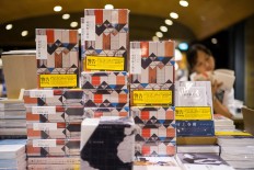 Copies of Japanese writer Haruki Murakami's latest novel 'Killing Commendatore' are displayed sealed in wrappers with yellow warning notices in a bookstore in Hong Kong on July 26, 2018. 