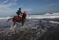 A man rides his horse along the beach. JP/Boy T. Harjanto