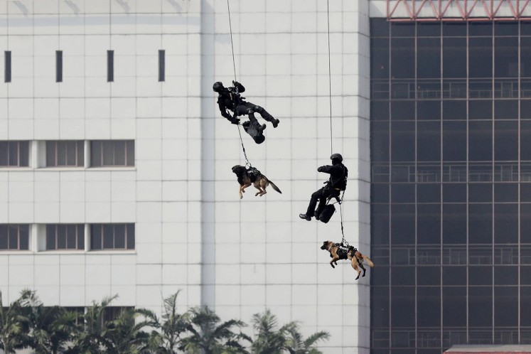 Personnel of the Army’s Special Forces (Kopassus), accompanied by sniffer dogs, rappel from a helicopter during a mock terror attack in Jakarta on Wednesday, July 25, 2018. With the involvement of military and police personnel, the training was held by the National Counterterrorism Agency (BNPT) as part of security preparations for the upcoming Asian Games. JP/Dhoni Setiawan