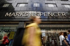 Shoppers walk past a Marks & Spencer shop on Oxford Street in central London on June 19, 2018. The Marks & Spencer sandwich may no longer appear on Parisian shelves without a post-Brexit trade deal, the supermarket's chairman warned in an interview published Friday.