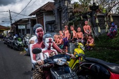 Young Balinese men ride a motorcycle. JP/Agung Parameswara