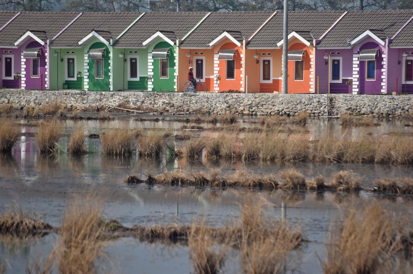 The colorful facade of newly built subsidized houses stand in a row in Kaliwungu, Kendal, Central Java.