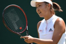 China's Peng Shuai reacts against Australia's Samantha Stosur during their women's singles first round match on the second day of the 2018 Wimbledon Championships at The All England Lawn Tennis Club in Wimbledon, southwest London, on July 3, 2018. 
Oli SCARFF / AFP