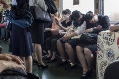 Tokyo subway passengers fall asleep. JP/Rosa Panggabean