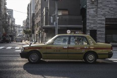 A taxi crosses an intersection in Tokyo. JP/Rosa Panggabean