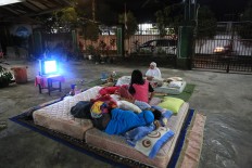 Under the stars: Residents sleep outside as they are afraid of sleeping indoors. JP/ Seto Wardhana