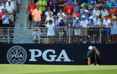 Koepka holds off Woods to win 100th PGA Championship