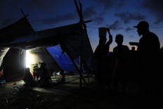 Safe place: People erect tents and try to get electricity and clean water. JP/ Seto Wardhana