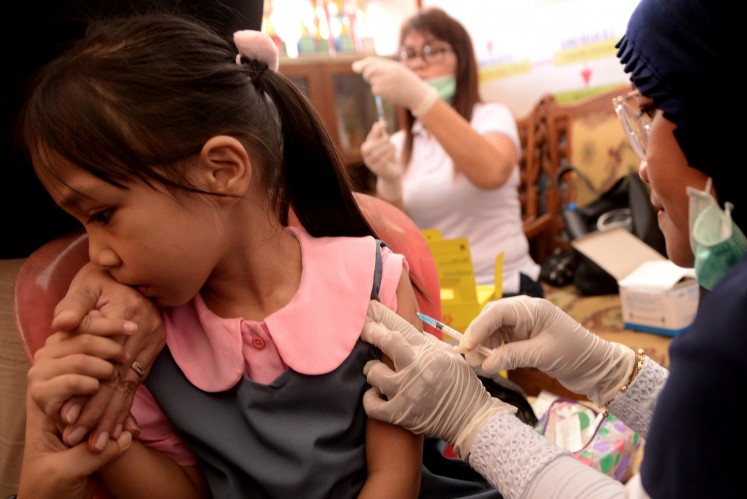 A child gets a measles and rubella vaccination in Manado, North Sulawesi, on Aug. 2, 2018.