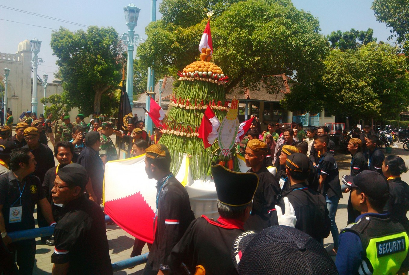 Palace guards 'abdi dalem' carry a 'gunungan' outside the palace. Image: The Jakarta Post