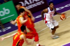Drive through: Philippines' Jorda Clarkson (right) controls the ball during a basketball game against China. JP/ Seto Wardhana