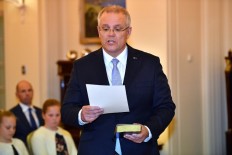 New Australian Prime Minister Scott Morrison takes part in an oath-taking ceremony to become the nation's new leader at Government House in Canberra on August 24, 2018. Scott Morrison was sworn in as Australia's seventh prime minister in 11 years on August 24 after a stunning party revolt against Malcolm Turnbull, which the new leader admitted had left the government 