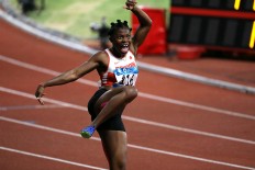 Happy dance: Edidiong Odiong of Bahrains shows her happiness after winnging gold in the women's 100 meters. JP/PJ Leo