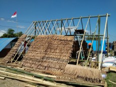 Quake survivors use salvaged materials to build better shelters, rebuild lives