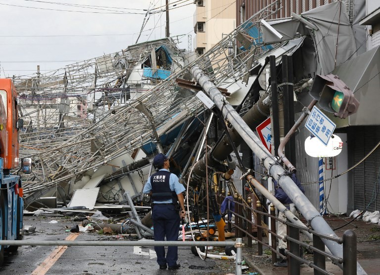 Powerful typhoon kills 9, shutters airport in Japan