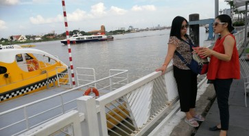 Wading through Saigon River on water bus