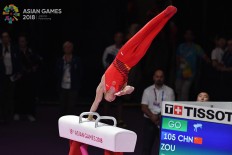 China's Jingyuan Zou competes on the pommel horse competition in the final at the artistic gymnastics event during the 2018 Asian Games in Jakarta on August.23. Inasgoc via Antara/ Wendra Ajistyatama