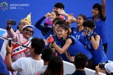 Thailand women’s hockey players take a photo with their supporters after a game against Indonesia at the Asian Games at the GBK Hockey Field in Senayan, Central Jakarta, on Saturday, August. 25. Thailand won 2-0. Inasgoc via Antara/ Dhoni Setiawan