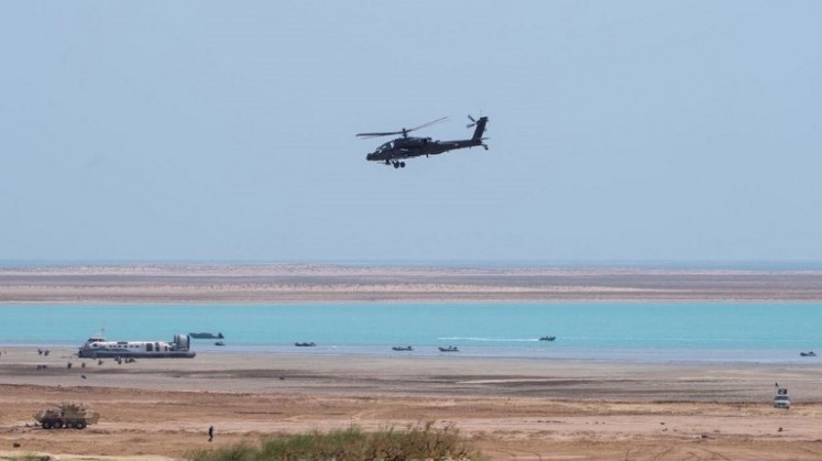 a US-built Boeing AH-64 Apache attack helicopter flying during the last day of the 