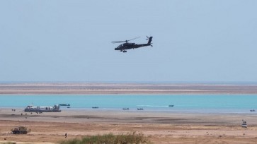 a US-built Boeing AH-64 Apache attack helicopter flying during the last day of the 