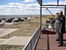 Russia's President Vladimir Putin (right) and China's Defense Minister Wei Fenghe watch the parade of the participants of the Vostok-2018 (East-2018) military drills at Tsugol training ground not far from the Chinese and Mongolian border in Siberia, on September 13, 2018. 
Alexey NIKOLSKY / SPUTNIK / AFP