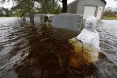 Floodwaters rise as killer storm stalks southeastern US