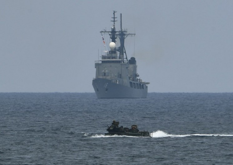 A US assault amphibious vehicle (AAV) manoeuvers past Philippine navy's frigate Ramon Alcaraz during the amphibious landing as part of the annual Philippines and US joint military exercise at the beach of Philippine navy's training camp in San Antonio, Zambales province northwest of Manila on May 9, 2018. The US and Philippine militaries launched major exercises on May 7 aimed at fighting global terrorism, while staying mostly quiet on Beijing's reported installation of missiles in the disputed South China Sea. 
TED ALJIBE / AFP