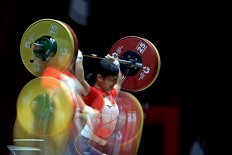 Japan's Takahashi Ibuki lifts weights during women's 48 kilogram weightlifting match. JP/Seto Wardhana
