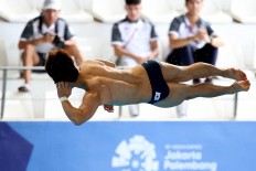 South Korea's Yeongnam Kim competes in the men's diving 3-meter springboard. JP/PJ Leo