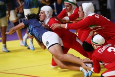 The Iranian women's team tackles an Indian athlete in the women's kabaddi final. The Iranians clinched the gold. JP/PJ Leo