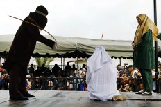 Man, woman fall unconscious in public floggings in Aceh